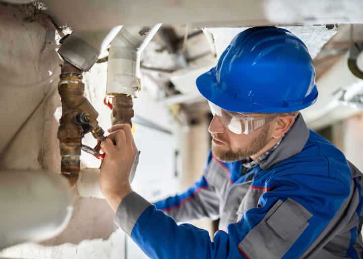 Expert in blue hard hat handling water damage repair in Woodstock, GA.